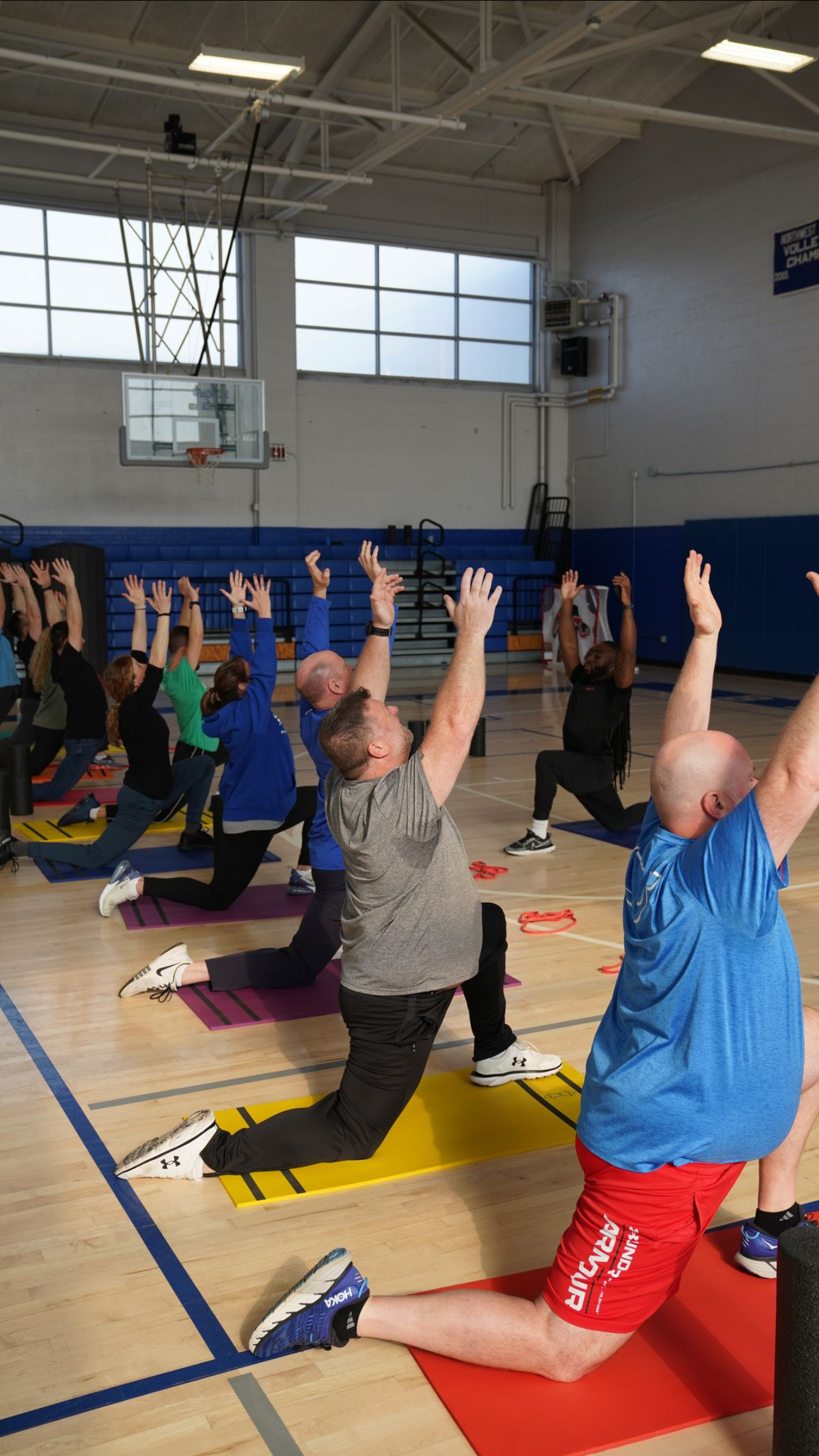 Corporate wellness group fitness class with stretching exercises